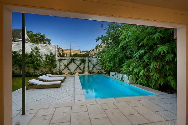 Cocktail pool at night with wetedge plaster and firerock pavers